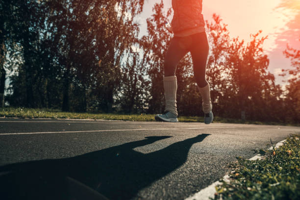 istock Young woman running on stadium track 1034461786