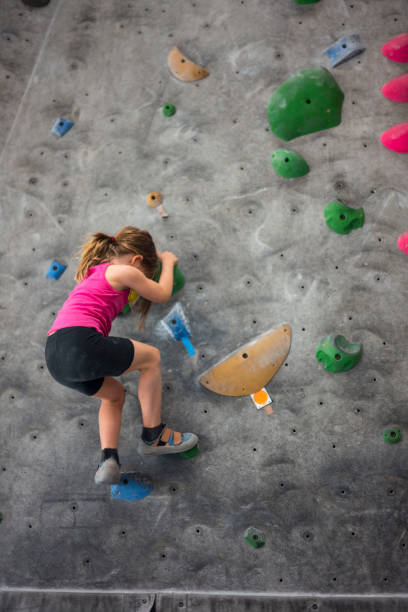 istock Young Girl on Climbing Wall 1034464652