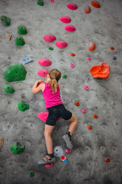 istock Young Girl on Climbing Wall 1034464656