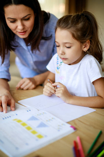 istock Mother and daughter working homework together 1034464986