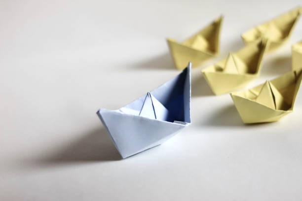 istock Origami boats. Leadership concept 1034469544