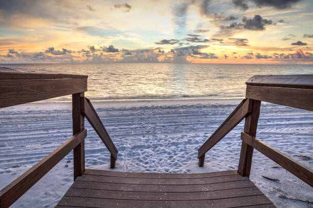 istock Boardwalk leading to the ocean at Vanderbilt Beach at sunset 1034473272