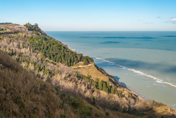 Coastline along the mount San Bartolo, near Pesaro; the village Fiorenzuola di Focara in the background stock photo