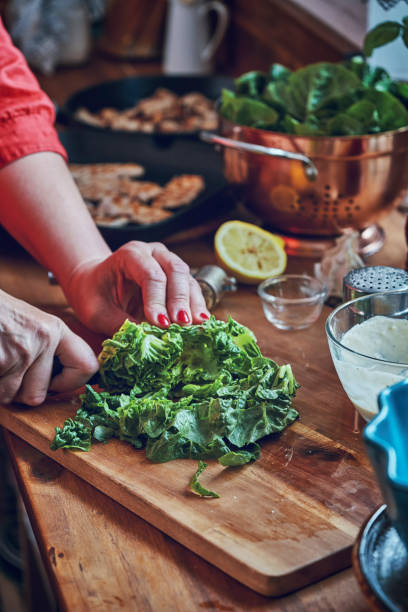 istock Preparing Cesar Salad with Chicken, Lettuce and Parmesan 1034477414