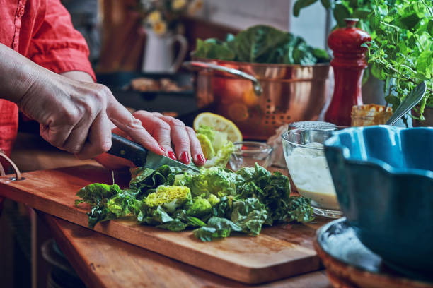 istock Preparing Cesar Salad with Chicken, Lettuce and Parmesan 1034477428