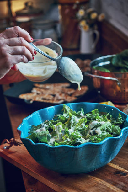 istock Preparing Cesar Salad with Chicken, Lettuce and Parmesan 1034477432