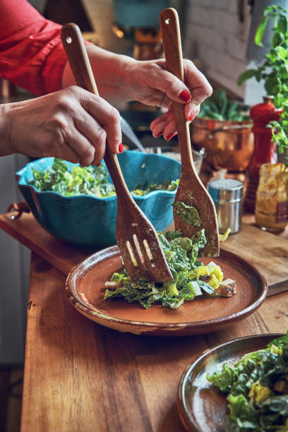 istock Preparing Cesar Salad with Chicken, Lettuce and Parmesan 1034477436