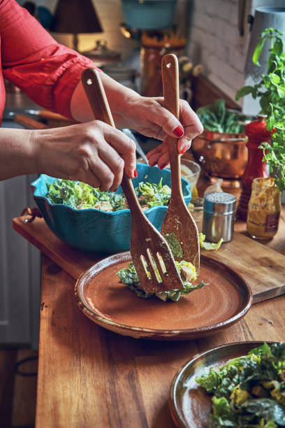 istock Preparing Cesar Salad with Chicken, Lettuce and Parmesan 1034477438
