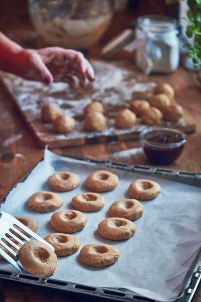 istock Preparing Peanut Butter Cookies with Marmalade in Domestic Kitchen 1034484056