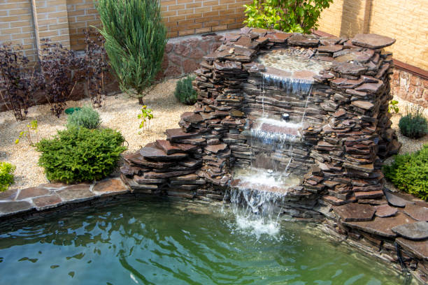 istock fountain with two overflows, in antique style. Using natural materials such as wild marble, slate, granite and basalt 1034485096