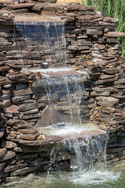 istock fountain with two overflows, in antique style. Using natural materials such as wild marble, slate, granite and basalt 1034485106