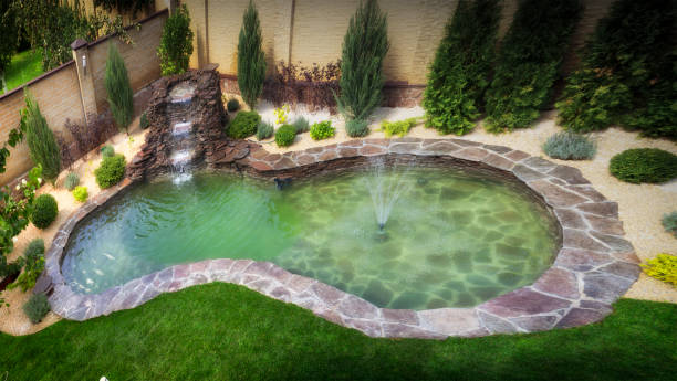 istock fountain with two overflows, in antique style. Using natural materials such as wild marble, slate, granite and basalt 1034485158