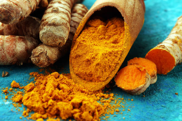 istock Turmeric powder and fresh turmeric on grey background 1034487514