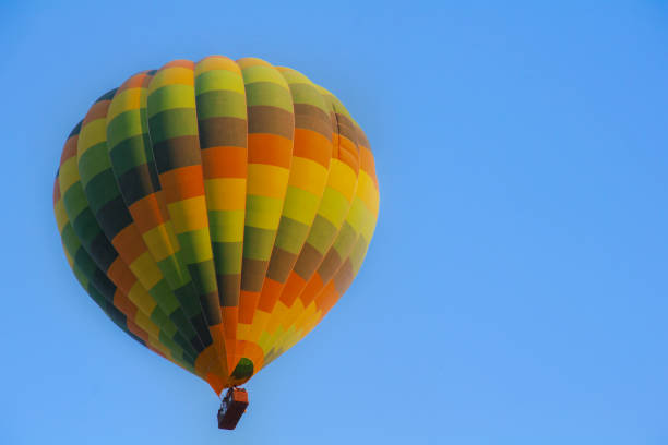 istock Yellow Hot Air Balloon on a Blue Background 1034488744