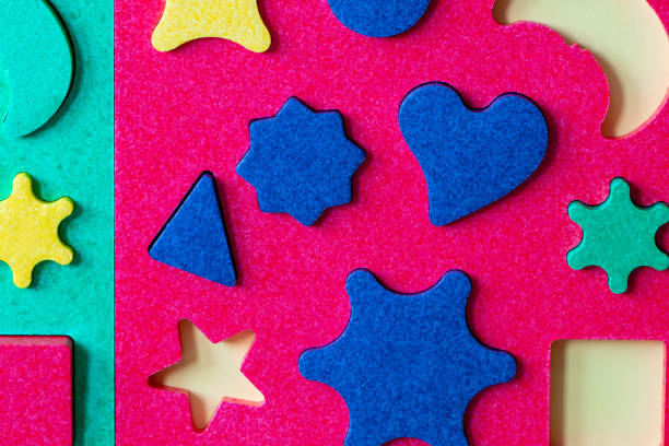bright colorful puzzle with geometric shapes close up.