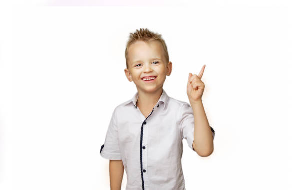 istock Boy in white shirt isolated on white background showing thumb up 1034490914