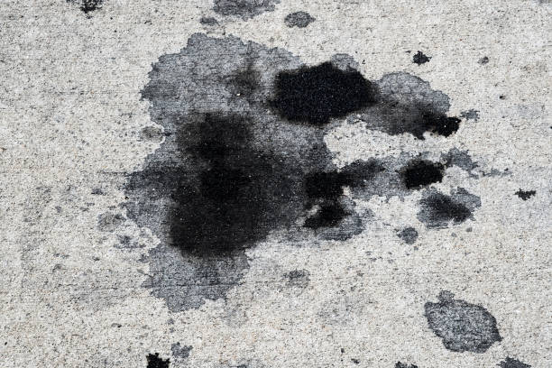 Motor oil stains on concrete pavement/texture background stock photo