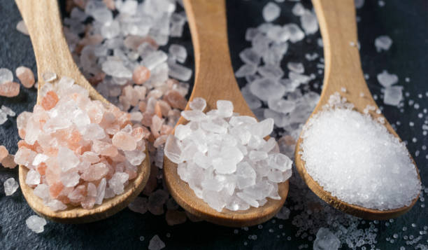 istock Different types of salt. Top view on three wooden spoons 1034496028