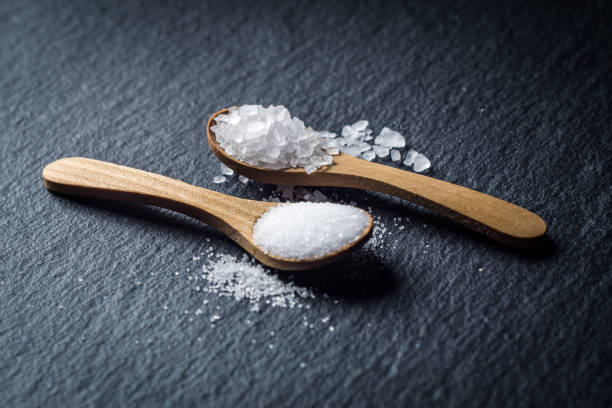 istock Different types of salt. Top view on two wooden spoons 1034496366