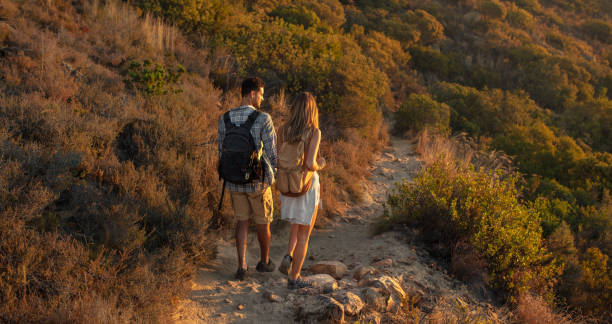 istock Hiker couple walking through mountain trail 1034497442