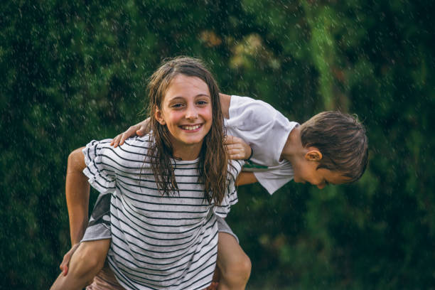 istock kids playing out i the rain 1034514984