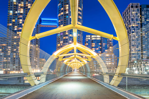 Stock photograph of a pedestrian bridge and new condo buildings in downtown Toronto, Ontario, Canada.
