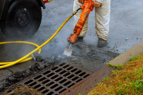 istock Man at work breaking asphalt on the street 1034515964