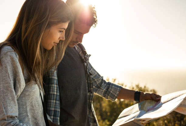 istock Tourist couple using a map to find the route on hike 1034515970