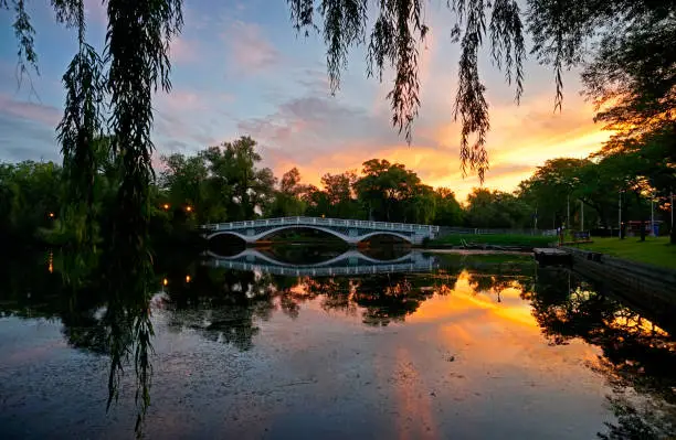 Toronto Centre Island with sunrise clould over arch bridge and pond at dawn