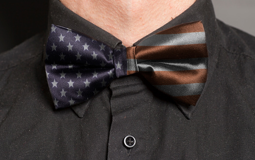 Man Dressed Black Shirt With Bow Tie with USA flag closeup
