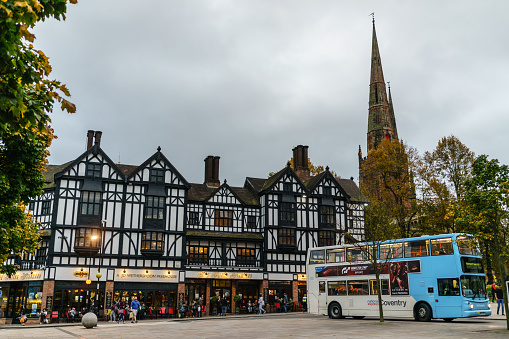 Coventry, UK - October 13, 2017 : Famous Pub chain Whetherspoon in Coventry city centre, Local Public Transport bus National Expresses making turn to collect new passengers in West Midland, UK