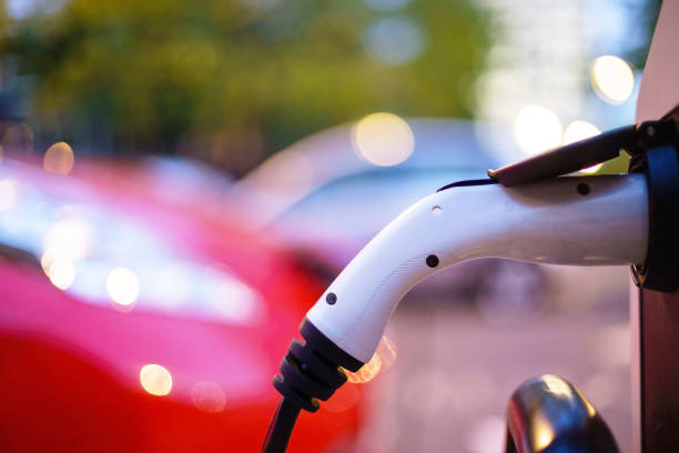 istock Electric Vehicle is changing in street. 1034529332