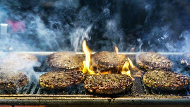istock Burgers on grill with smoke around 1034529548