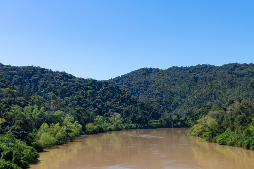View of the river 'Rio Itajaí-Açu' surrounded by the 'mata atlântica' in Blumenau, Santa Catarina state - Brazil
