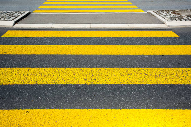 istock Yellow pedestrian crossing sign on asphalt 1034533806