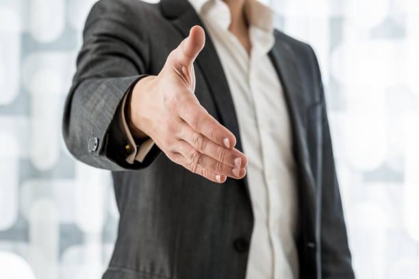 istock Businessman offering hand in handshake 1034538090