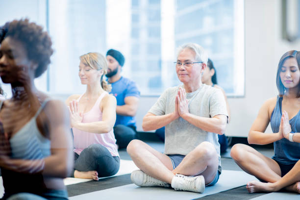 istock Man poses with enthusiasm during group yoga 1034539928