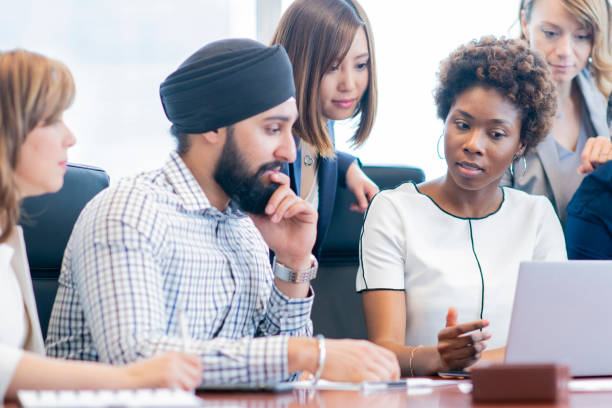 istock Diverse group of businesspeople meets at a conference table 1034539946