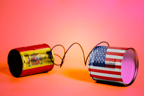 istock tin can phone with USA and Spain Flags. communication concept 1034555596
