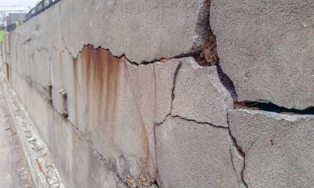 old foundation wall with cracks and chips stock photo