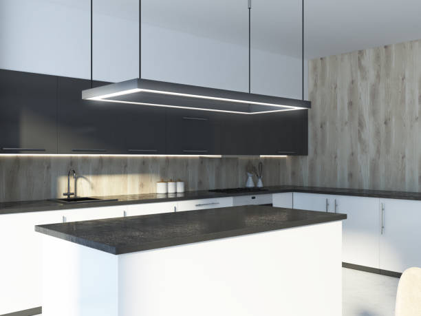 istock Black kitchen island in a wooden wall room 1034576386