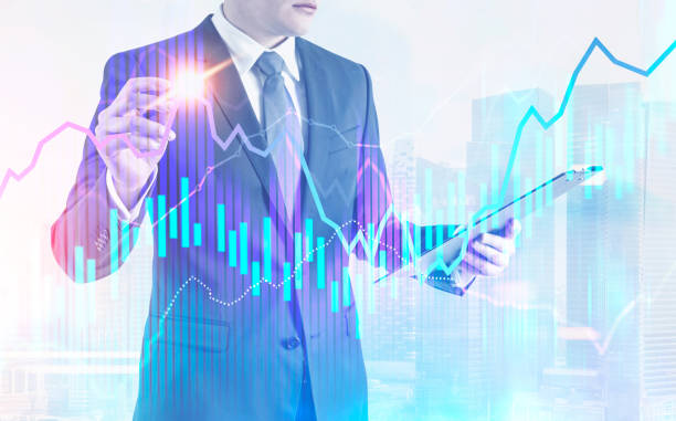 istock Businessman with glowing pen, graphs in a city 1034576466