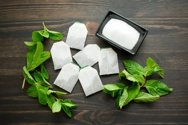 Tea bags, mint leaves, and sugar