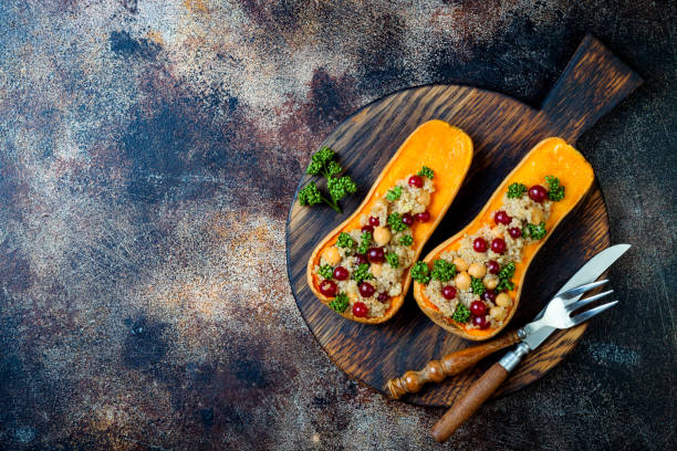 istock Stuffed butternut squash with chickpeas, cranberries, quinoa cooked in nutmeg, cloves, cinnamon. Thanksgiving dinner recipe. Vegan healthy seasonal fall or autumn food 1034584204