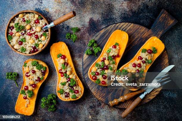 Stuffed Butternut Squash With Chickpeas Cranberries Quinoa Cooked In Nutmeg Cloves Cinnamon Thanksgiving Dinner Recipe Vegan Healthy Seasonal Fall Or Autumn Food Stock Photo - Download Image Now