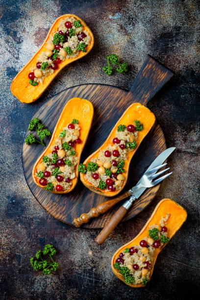 istock Stuffed butternut squash with chickpeas, cranberries, quinoa cooked in nutmeg, cloves, cinnamon. Thanksgiving dinner recipe. Vegan healthy seasonal fall or autumn food 1034584216