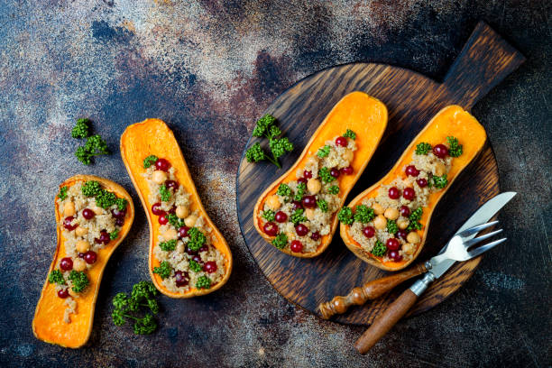 istock Stuffed butternut squash with chickpeas, cranberries, quinoa cooked in nutmeg, cloves, cinnamon. Thanksgiving dinner recipe. Vegan healthy seasonal fall or autumn food 1034584244