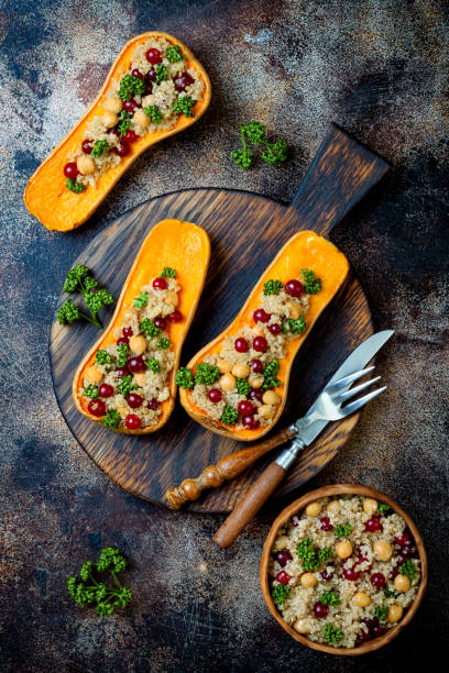 istock Stuffed butternut squash with chickpeas, cranberries, quinoa cooked in nutmeg, cloves, cinnamon. Thanksgiving dinner recipe. Vegan healthy seasonal fall or autumn food 1034584248
