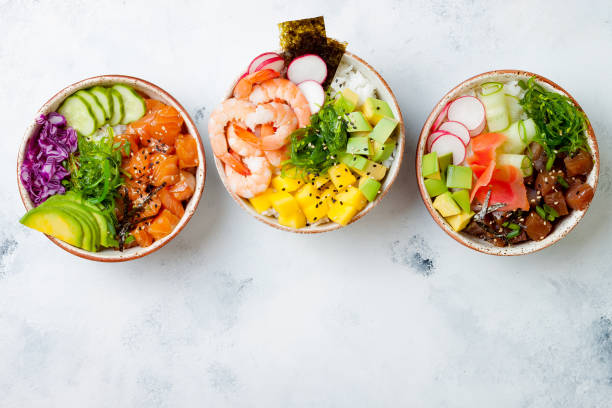 hawaiian salmon, tuna and shrimp poke bowls with seaweed, avocado, mango, pickled ginger, sesame seeds. top view, overhead, flat lay - healthy eating food rice high angle view imagens e fotografias de stock