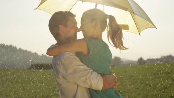 istock CLOSE UP: Cheerful young couple shares a romantic moment while dancing in rain. 1034600514